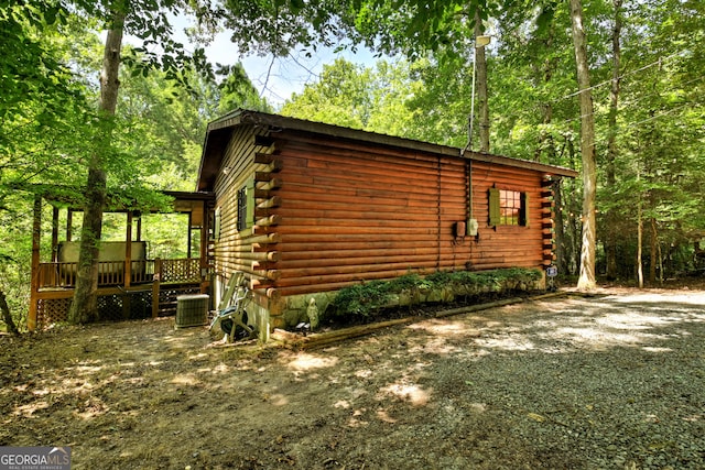 view of side of property with central AC unit and a deck