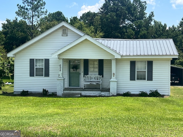 view of front of house with a front yard and a porch