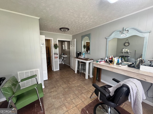 bathroom with a textured ceiling, crown molding, and tile patterned flooring