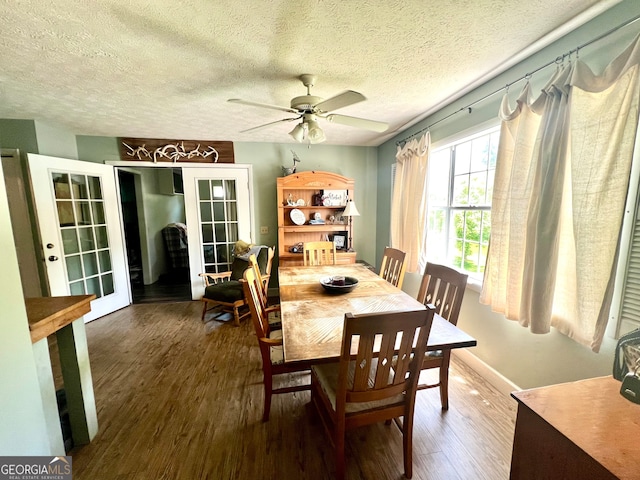 dining space featuring ceiling fan, a textured ceiling, french doors, and wood-type flooring