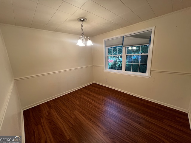 unfurnished room featuring hardwood / wood-style flooring and a chandelier