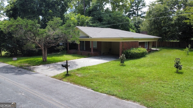 ranch-style home featuring a front lawn and a carport