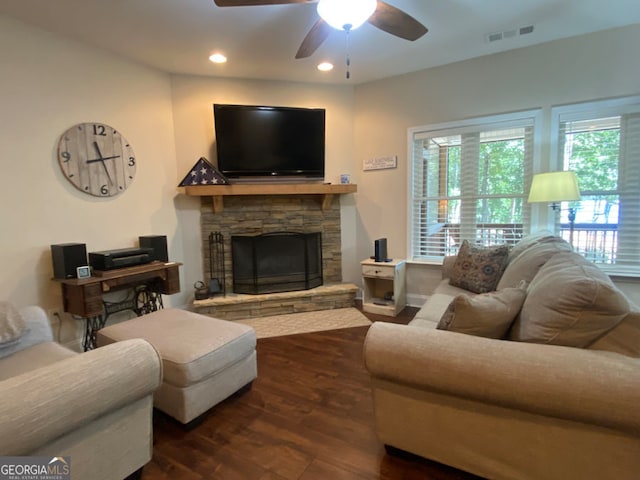 living room with a fireplace, dark hardwood / wood-style floors, and ceiling fan