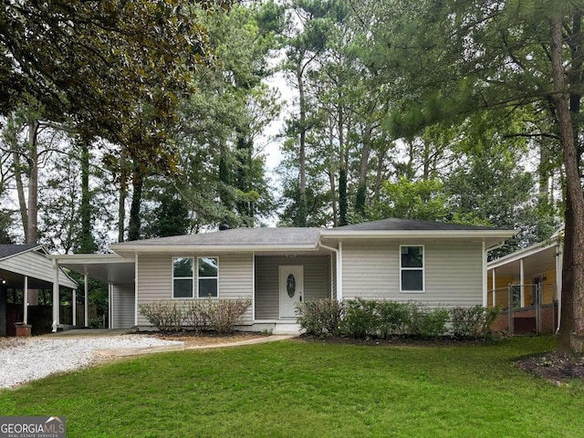 view of front of home with a front lawn and a carport