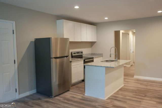 kitchen with appliances with stainless steel finishes, sink, light hardwood / wood-style flooring, and white cabinets