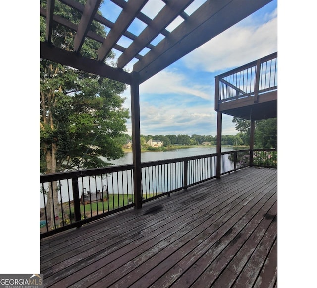 deck featuring a water view and a pergola