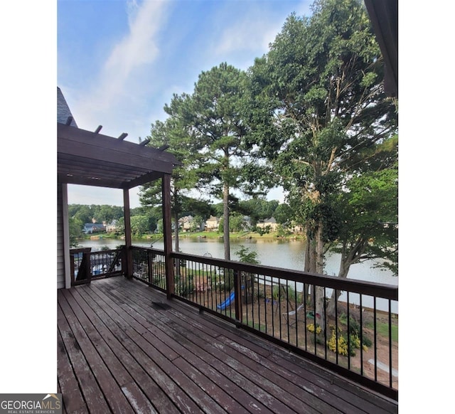 wooden deck featuring a pergola and a water view