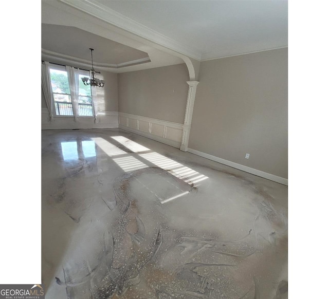 unfurnished room featuring a chandelier, concrete floors, and ornamental molding