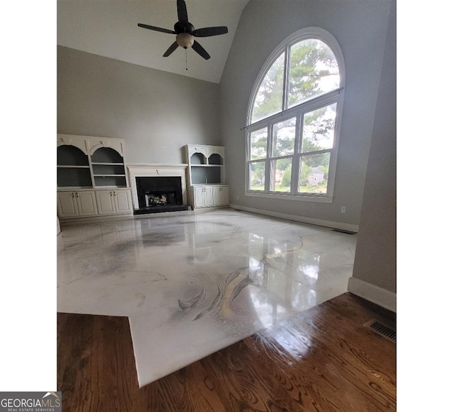 unfurnished living room featuring ceiling fan, vaulted ceiling, and light hardwood / wood-style floors