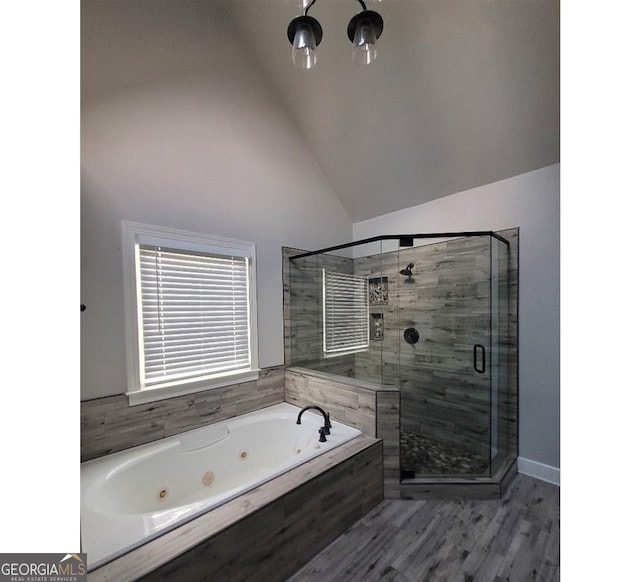 bathroom with lofted ceiling and shower with separate bathtub