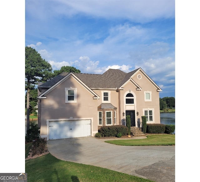 view of front facade featuring a garage and a front lawn