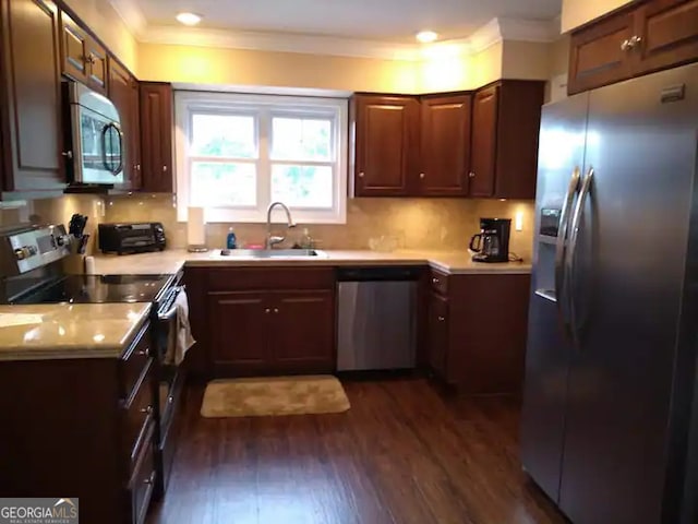 kitchen featuring sink, appliances with stainless steel finishes, and dark wood-type flooring