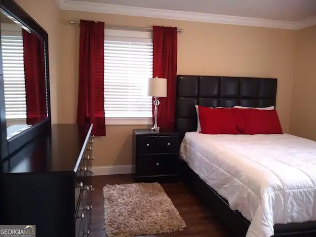 bedroom featuring dark hardwood / wood-style flooring and ornamental molding