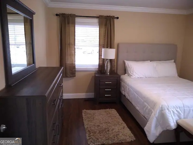 bedroom with crown molding and dark hardwood / wood-style flooring