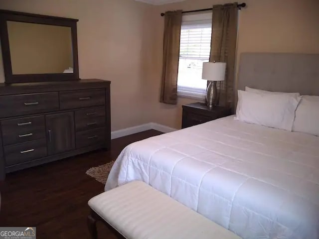 bedroom with dark wood-type flooring