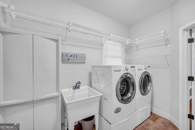 clothes washing area featuring independent washer and dryer and sink