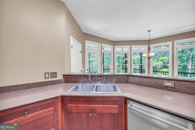 kitchen with an inviting chandelier, stainless steel dishwasher, sink, and pendant lighting