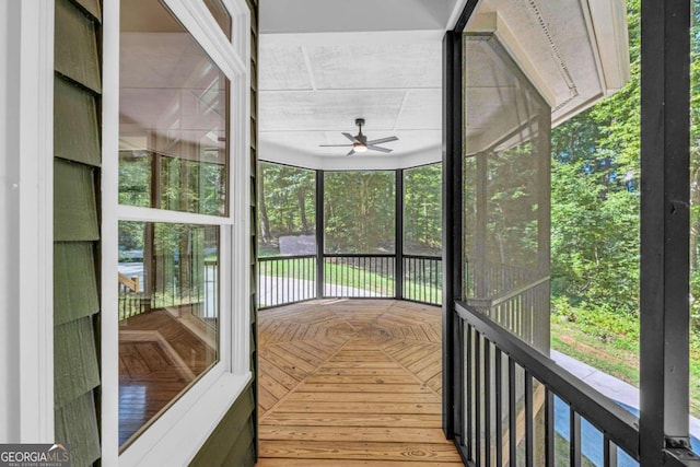 unfurnished sunroom featuring ceiling fan