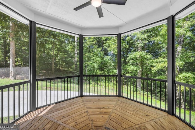 unfurnished sunroom with ceiling fan