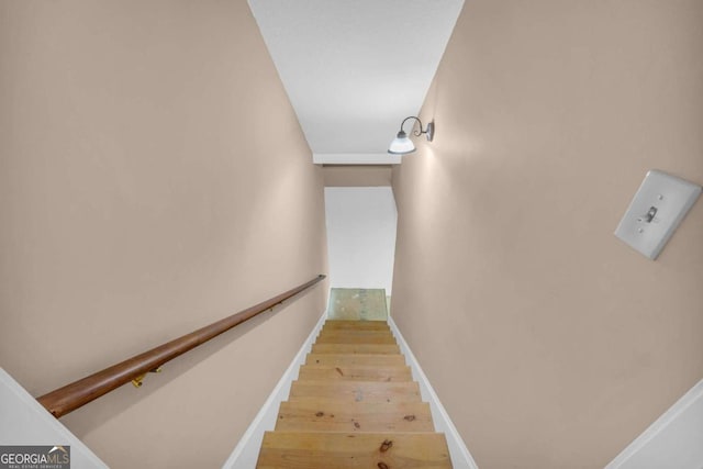 stairs with baseboards and wood finished floors