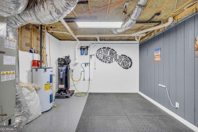 basement with electric water heater and wooden walls