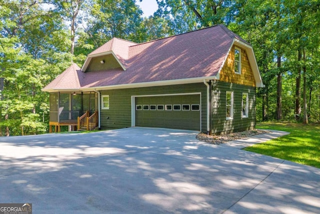 view of front of house with a garage and a sunroom