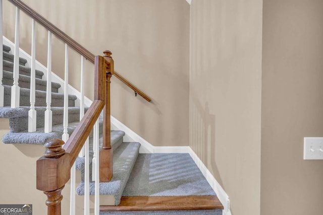 stairway featuring baseboards