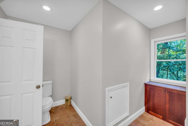 bathroom with toilet and tile patterned flooring