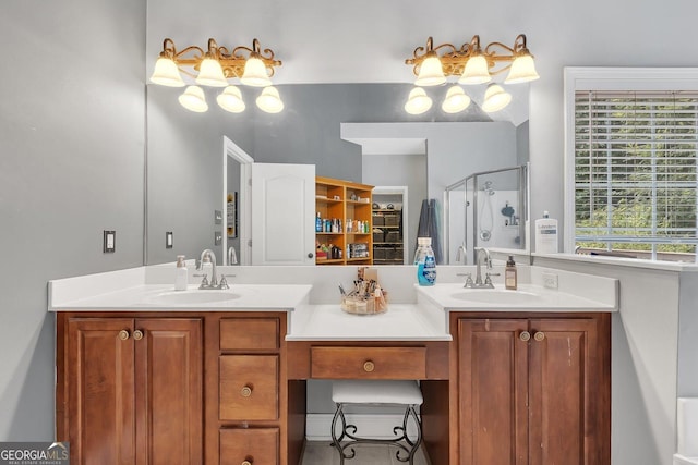 bathroom featuring vanity, a shower with shower door, and plenty of natural light