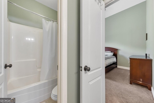 bathroom featuring toilet and shower / bath combo