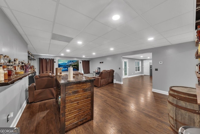 bar with dark hardwood / wood-style flooring