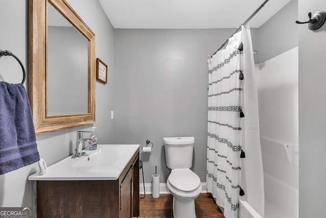 bathroom featuring vanity, hardwood / wood-style flooring, and toilet