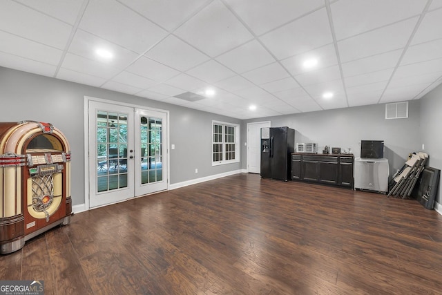 living room featuring french doors, a paneled ceiling, and dark hardwood / wood-style floors