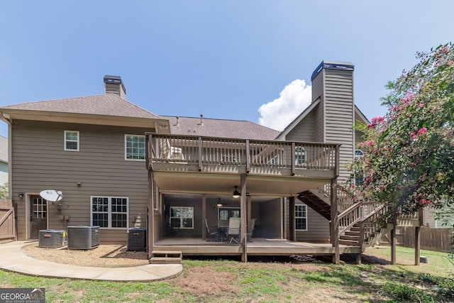 rear view of house with central AC and a deck