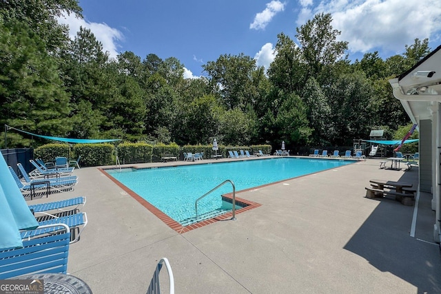 view of swimming pool with a patio area