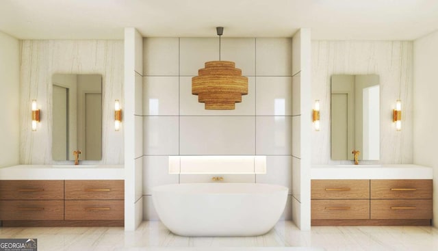 full bath with a freestanding tub, two vanities, and marble finish floor