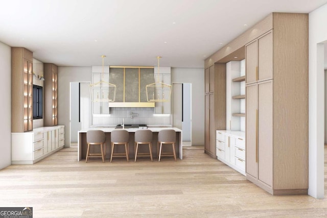 kitchen featuring light wood finished floors, light countertops, light brown cabinetry, and modern cabinets