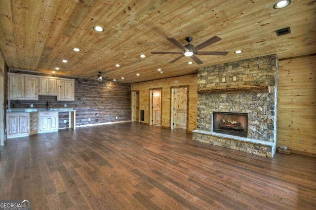 unfurnished living room featuring wooden walls, hardwood / wood-style flooring, and wood ceiling