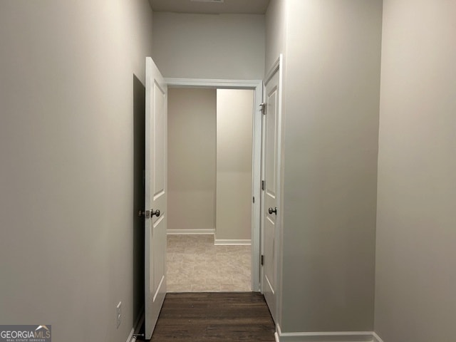 hallway with dark hardwood / wood-style floors