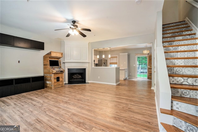 living room featuring light hardwood / wood-style flooring and ceiling fan