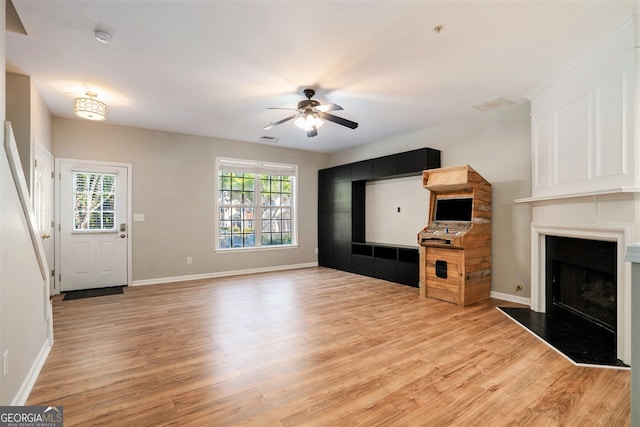 unfurnished living room featuring light hardwood / wood-style flooring and ceiling fan