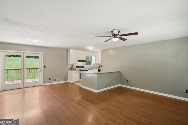 unfurnished living room featuring hardwood / wood-style floors and a wealth of natural light