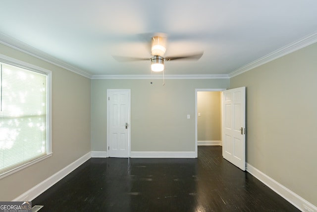 unfurnished room featuring dark wood-type flooring, ceiling fan, and crown molding