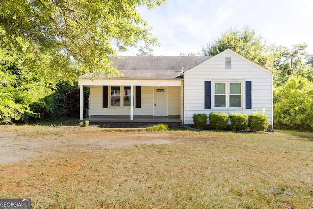 ranch-style house with a front lawn and covered porch