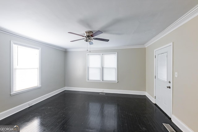 empty room with ceiling fan, dark wood finished floors, ornamental molding, visible vents, and baseboards