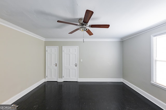 unfurnished room featuring dark wood-type flooring, ceiling fan, a wealth of natural light, and crown molding