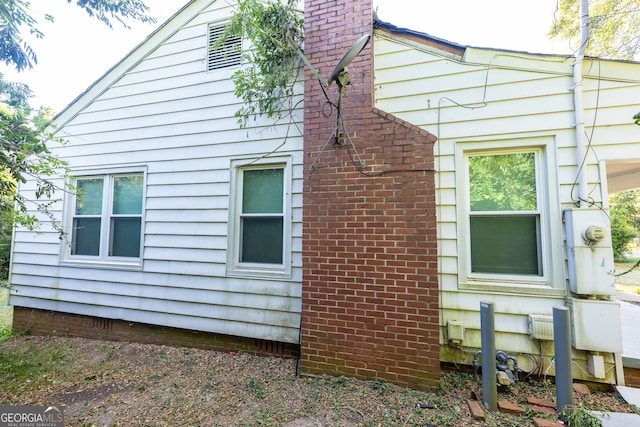 view of home's exterior featuring a chimney