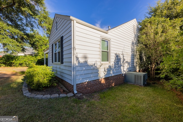 view of home's exterior featuring a yard and central air condition unit