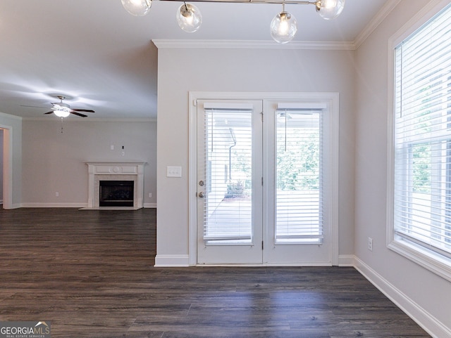 doorway featuring ceiling fan, a fireplace, dark wood-type flooring, and ornamental molding