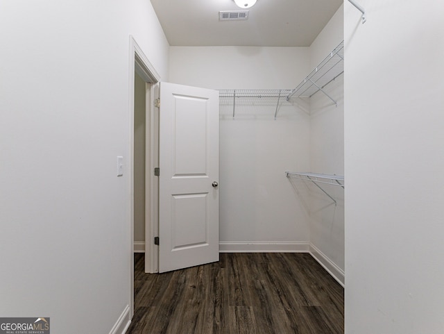 walk in closet featuring dark hardwood / wood-style flooring